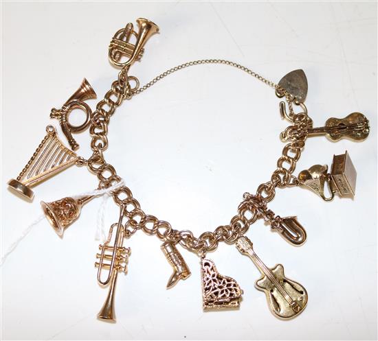 9ct gold charm bracelet, double curb link with padlock clasp and 11 charms